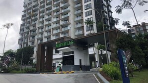 A multi-story building with a prominent entrance, balconies, and a sign indicating 'LBS MIDHILLS'. - Midhills Genting by Manhattan (Genting Highlands)