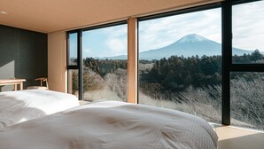 A bedroom with a large window, a bed, a small table, and a chair. - nakafuji (Fujinomiya)
