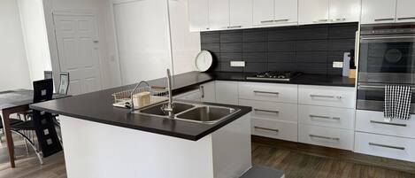 Fridge, stovetop, cookware/dishes/utensils, dining tables