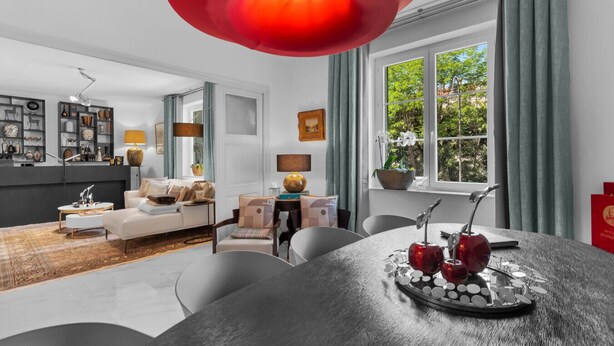 A modern living room with a dining area, a kitchen, and a large window with curtains. - Luxurious 3 bedroom apartment, in the heart Cannes (Cannes)