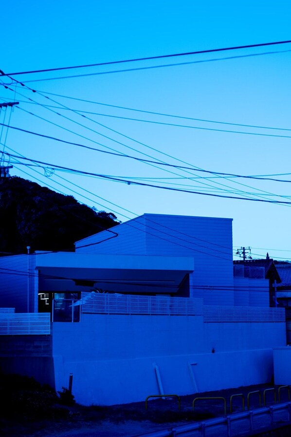 A modern building with a flat roof and a large window.