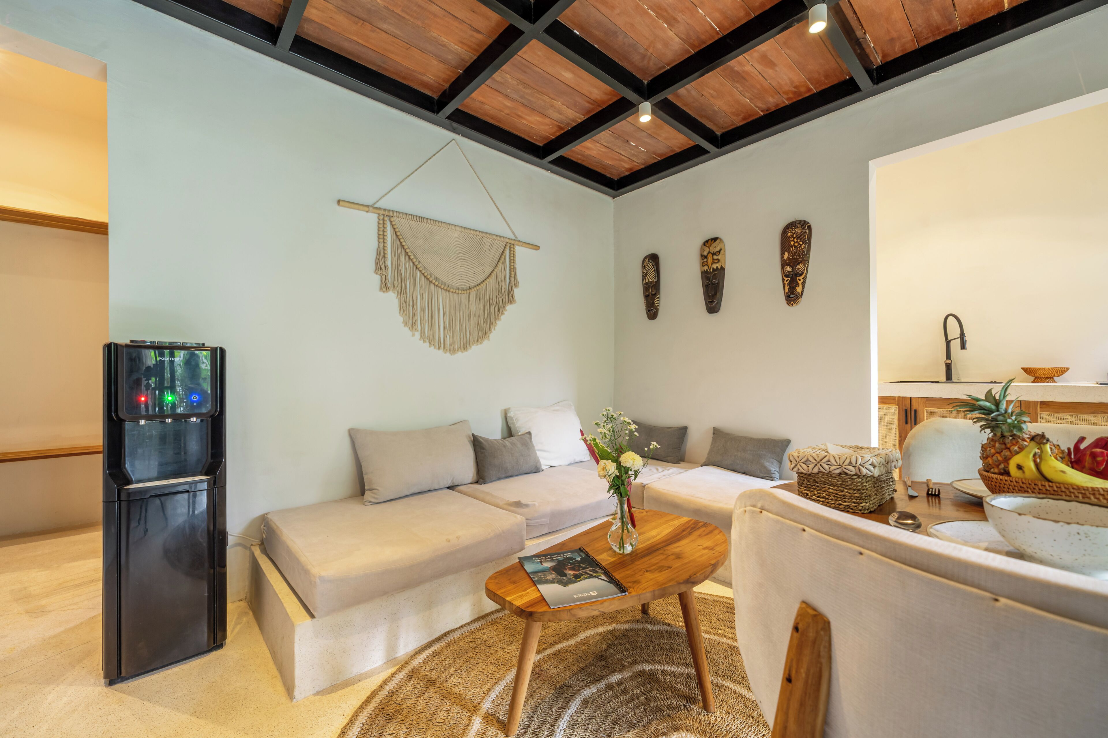 A modern living room with a sofa, coffee table, and decorative items.