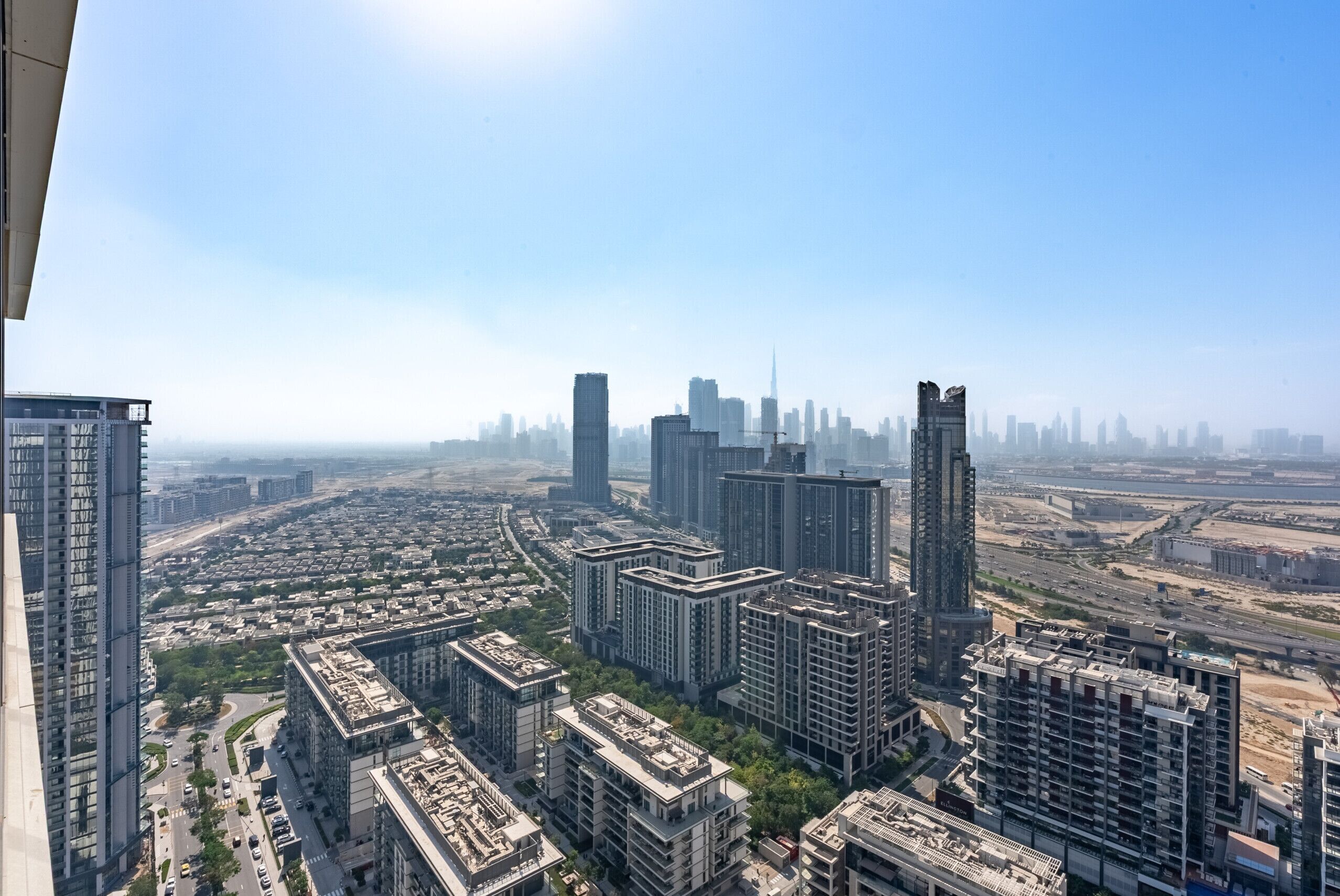 A high-rise building with multiple floors, large windows, and a view of a cityscape.