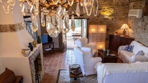 A cozy living room with white furniture, a fireplace, and a view of the outdoors. - Sea Pool and Relax Cefalù (Cefalù)