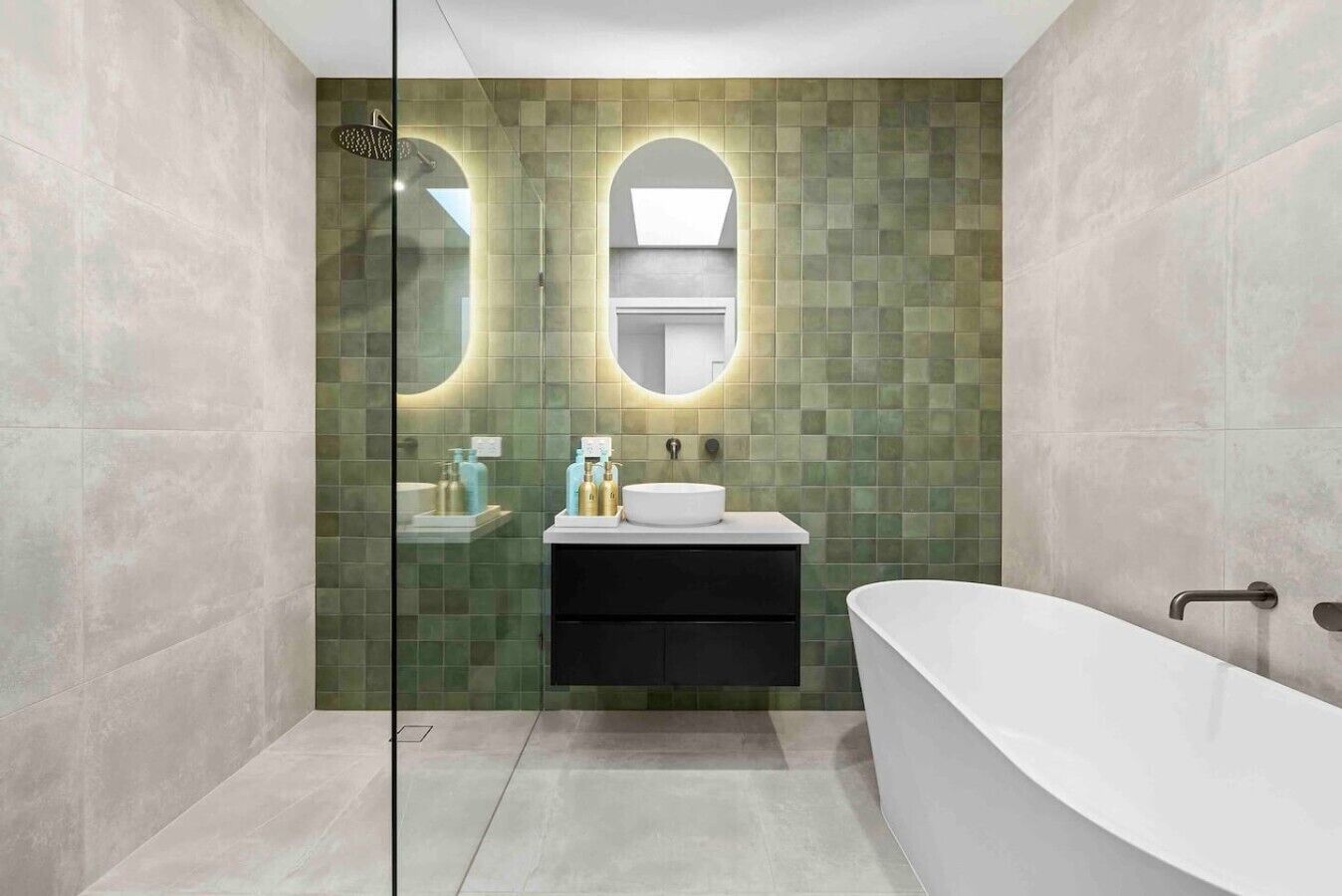A modern bathroom with a freestanding bathtub, a glass-enclosed shower, and a vanity with a sink and mirror.