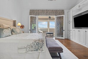 A bedroom with a large bed, a bench, a TV, and a view of the outdoors. - Luxurious Mtn Retreat w/ Lake Glenville Views! (Glenville)