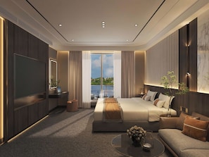 Une chambre d’hôtel moderne avec un grand lit, un canapé, une télévision et une vue sur l’extérieur.