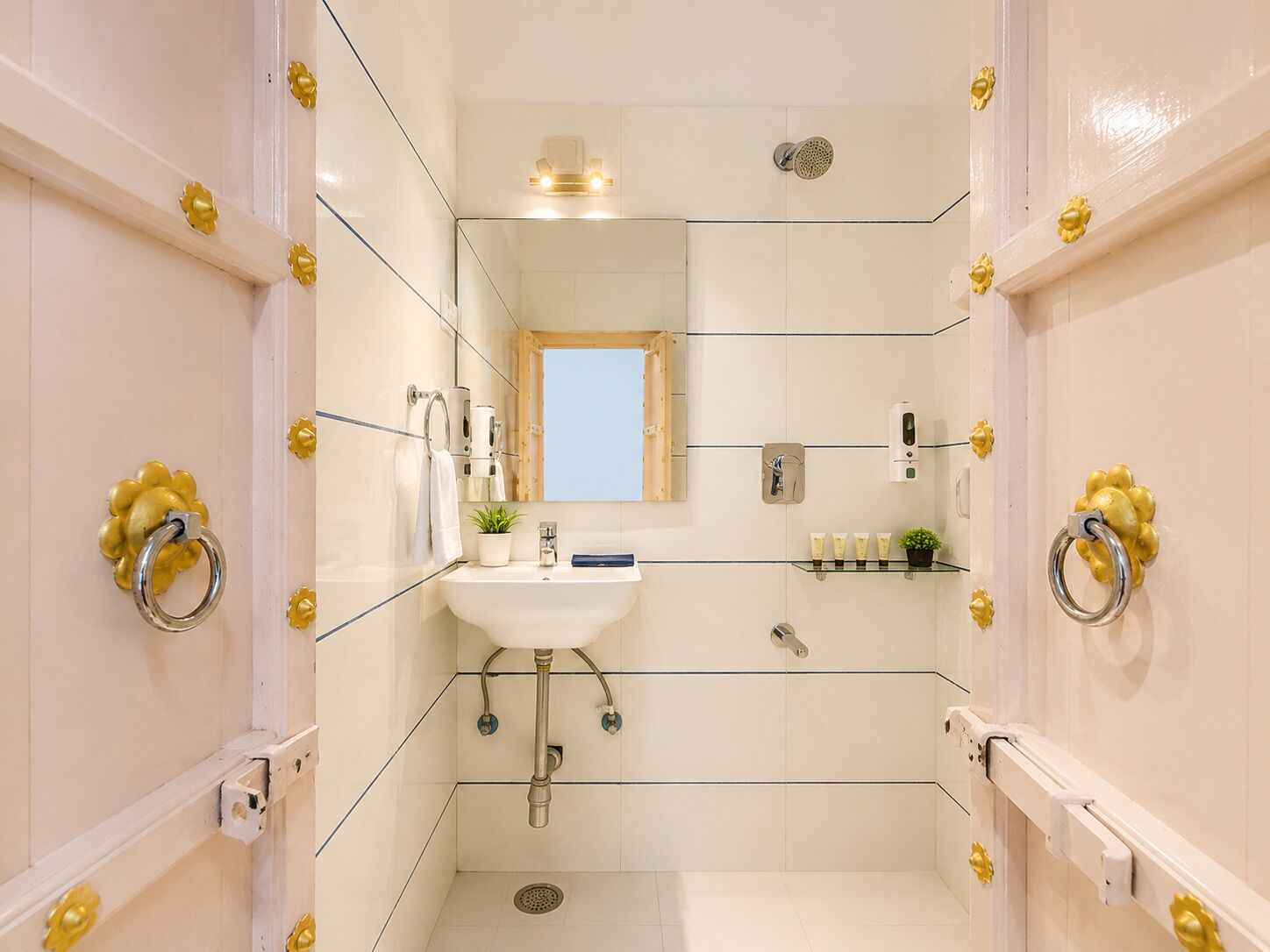 A bathroom with a sink, mirror, shower, and toilet.