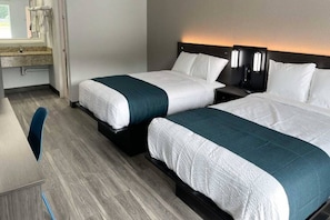 A hotel room with two beds, a desk, and a bathroom. - 2 Beds|Access|Tub|Nsmk|Micfridg (West Columbia)