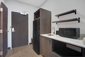 A compact kitchen with a refrigerator, microwave, and built-in oven. - 2 Queen Beds|Nsmk, Kitchen (Monahans)