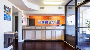 A reception area with a counter, framed pictures, and a large window.