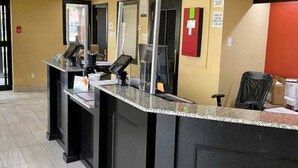 A reception desk with a check-in counter, a computer, and a fire extinguisher on the wall. - 2 Queen Beds | Smoking, Micfridge (Oklahoma City OK)
