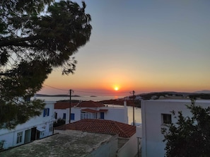 A coastal view with buildings and a sunset.