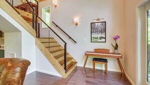 A wooden staircase with a handrail, a piano, a framed picture, and a potted plant. - 'The Appalachian Hideaway' w/ Hiking Trails & Deck (Spencer)