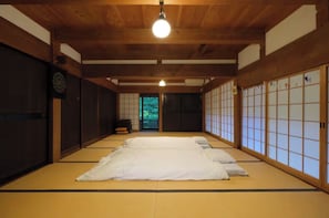 A traditional Japanese room with tatami flooring, shoji screens, and a hanging light fixture. - Entire Traditional Japanese House Rental Riversi / Kohaya City Fukui (Kohaya City)