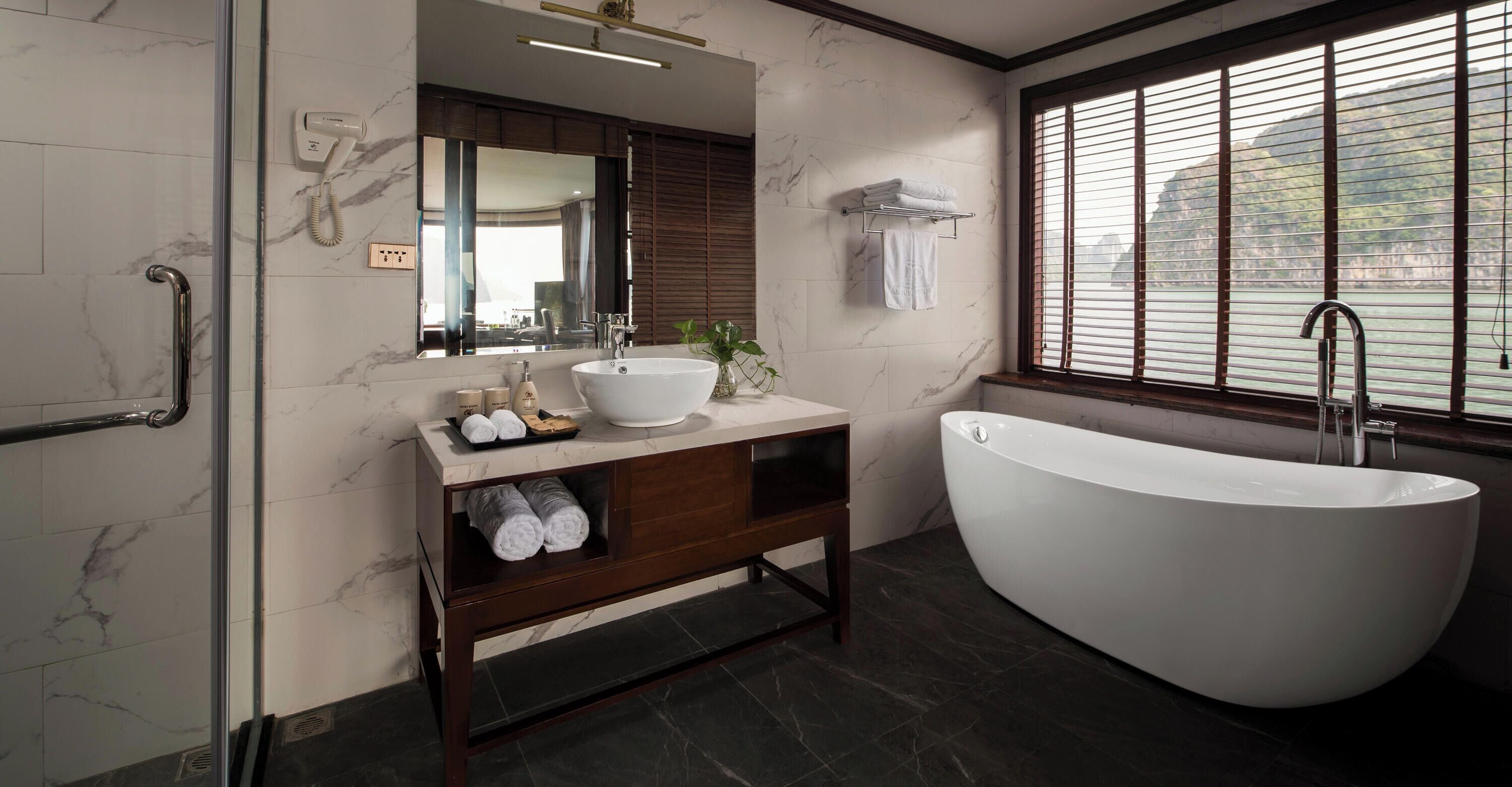 Separate bathtub and shower, hair dryer, slippers, towels