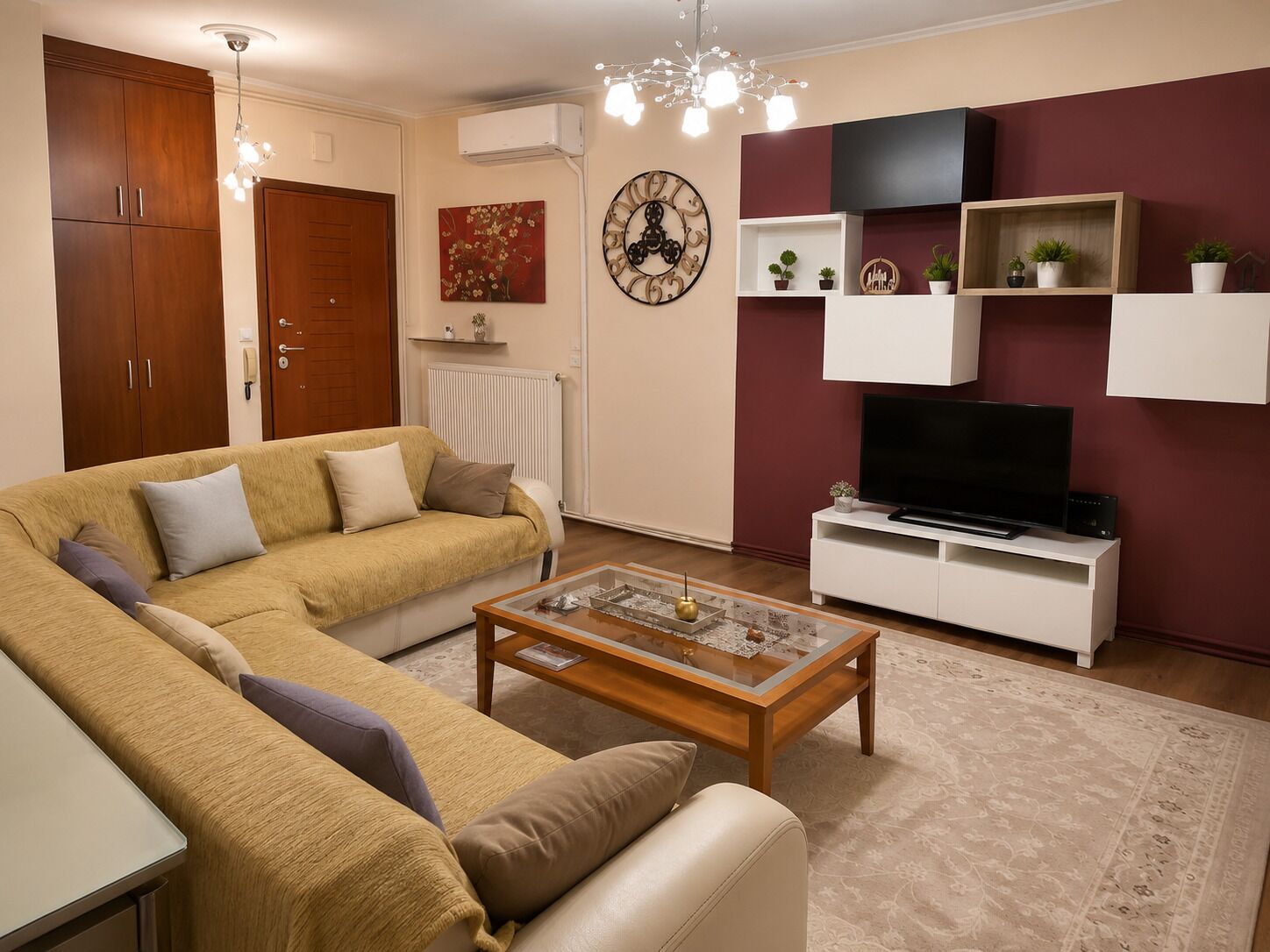 A living room with a sofa, coffee table, TV, and decorative items.