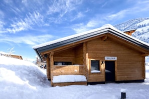 A wooden cabin with a sign reading 'SAUNA' indicating a sauna facility. - Rauris Penthouse with Fireplace (Rauris)