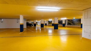 A parking garage with yellow floors and white pillars. - Rauris Suite with Breakfast & Sauna (Rauris)