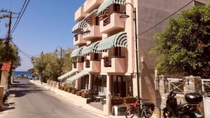 A hotel with a multi-story structure, outdoor seating, and a view of the sea. - Aphrodite Hotel Syros  (Syros)
