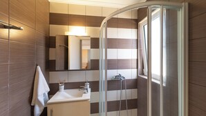 A modern bathroom with a glass shower enclosure, a sink, and a mirror. - Fiore D’oriente Apartment 2, Apartment (Rhodes)