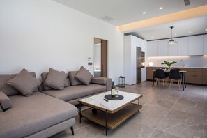 A modern living room with a sofa, a coffee table, and a dining area with chairs and a table. - Escape to Casadi Fileri Villa, a brand-new property in the area of Ialysos. (Rhodes)