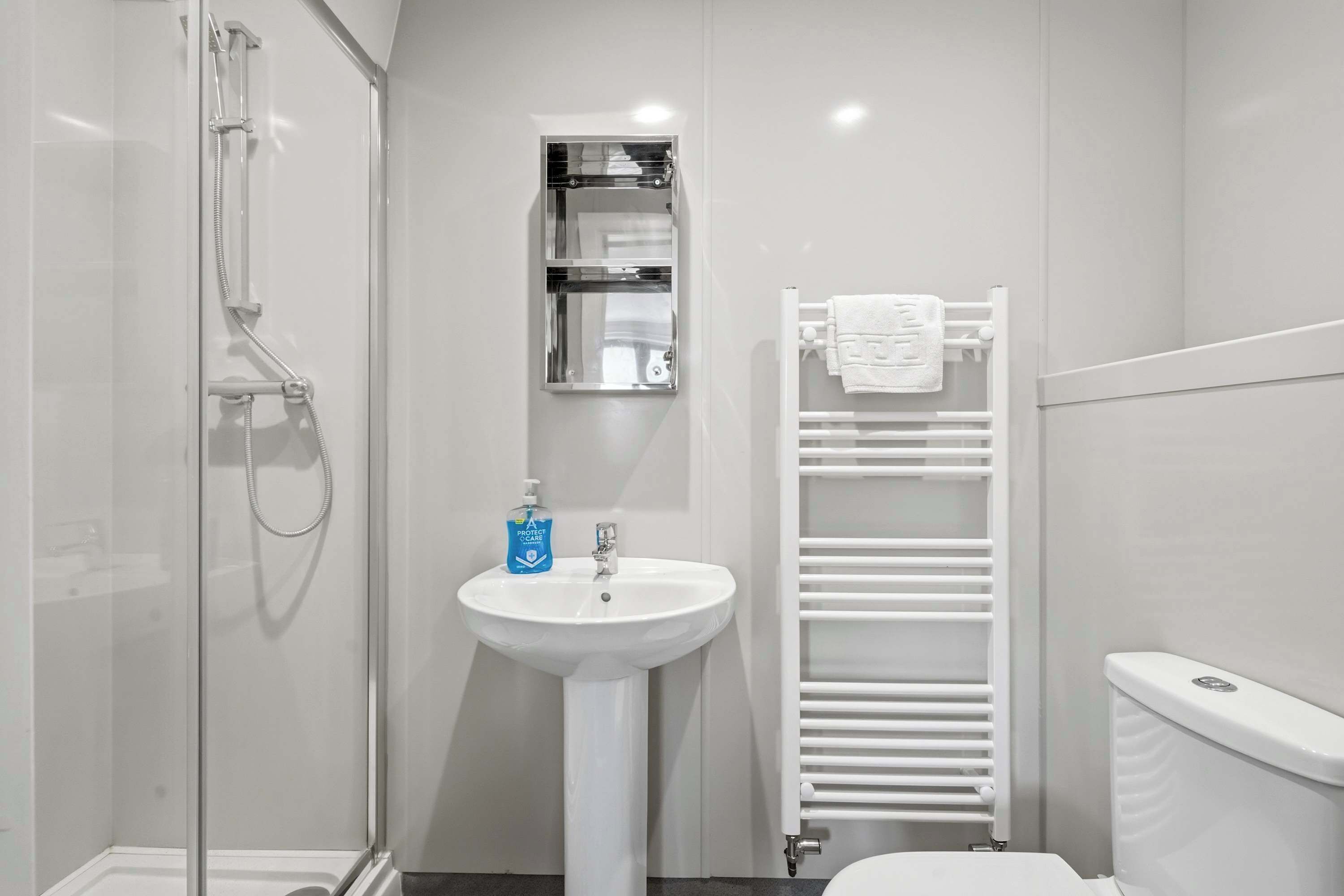 Shower, hair dryer, towels, shampoo