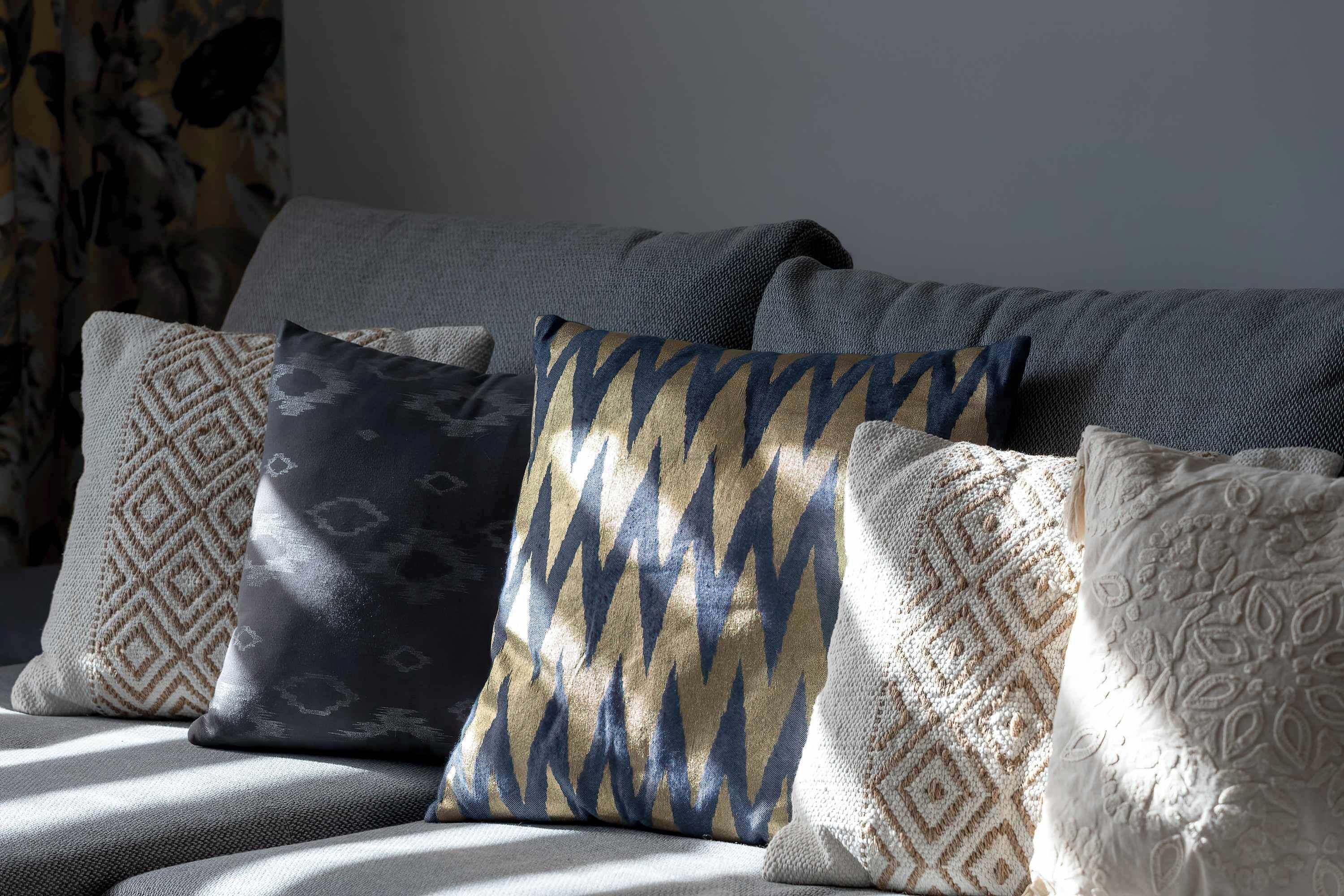 A sofa with patterned cushions.