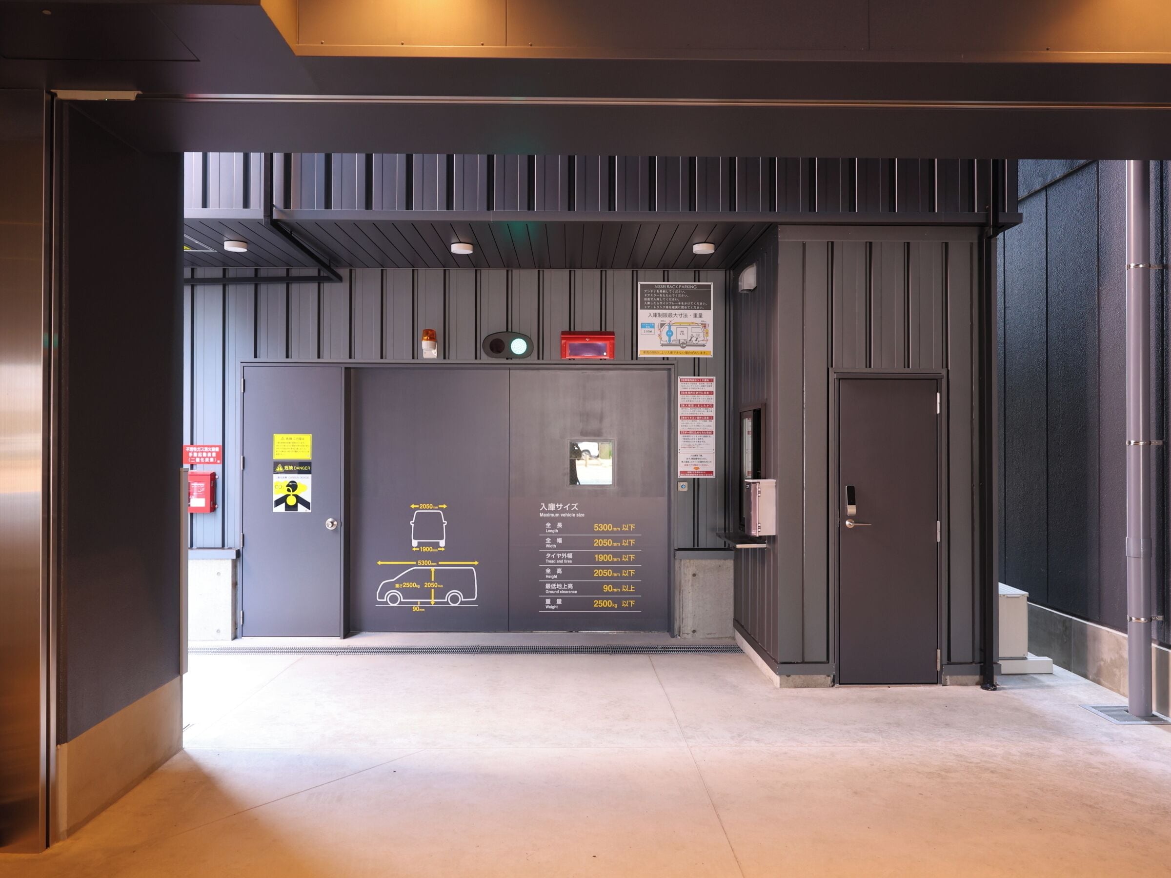 A modern elevator with a digital display indicating vehicle size restrictions.
