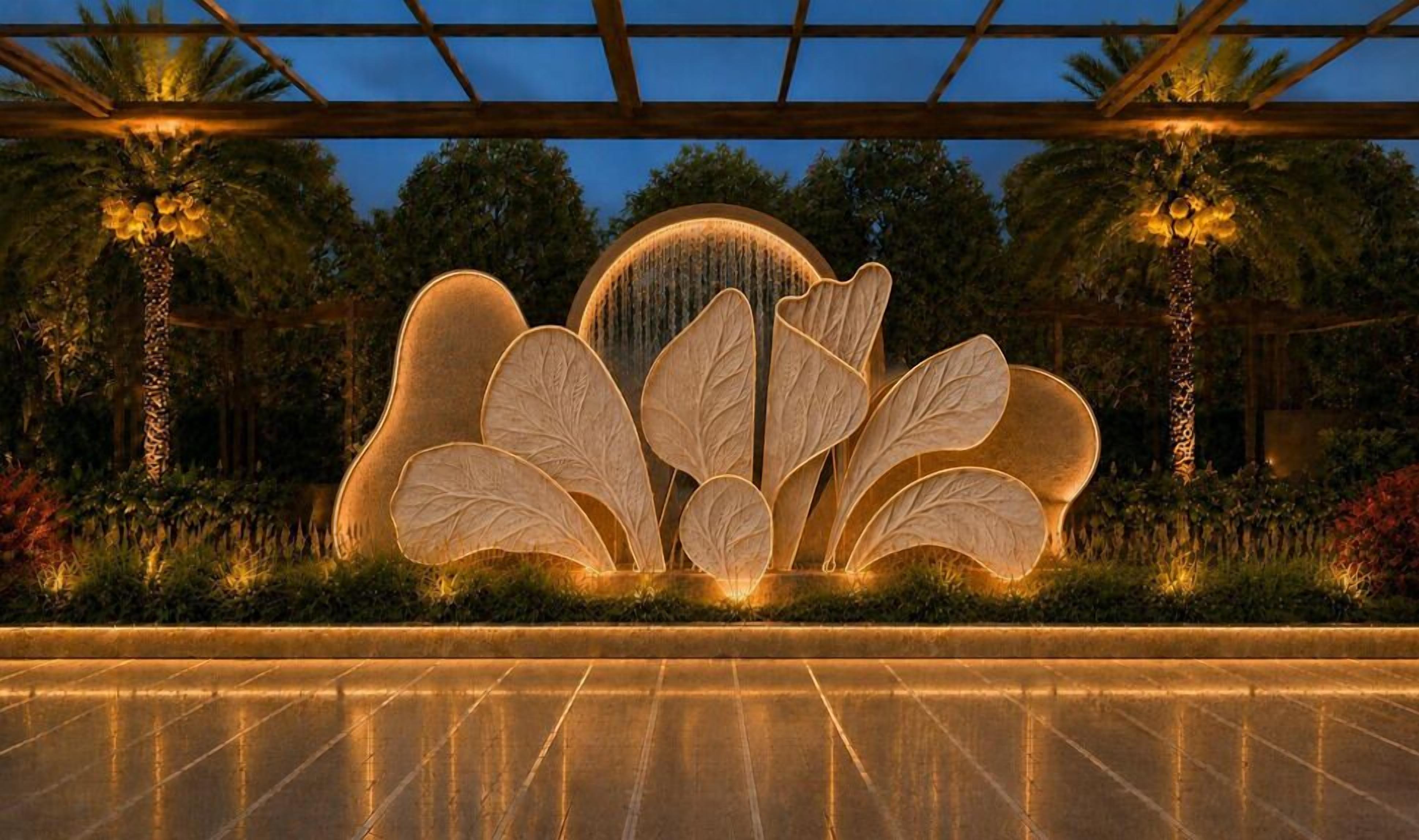 A water feature with leaf-shaped structures and a central fountain, surrounded by palm trees and greenery.