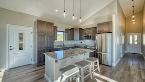 A modern kitchen with granite countertops, stainless steel appliances, and wooden cabinets. - Spacious mountain chalet with breathtaking views on all sides, just 15 minutes from Monarch Ski Area and 15 minutes from downtown Salida. (Salida)