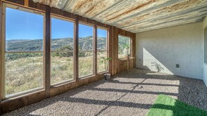 A room with large windows, a gravel floor, and a view of a hilly landscape. - Spacious mountain chalet with breathtaking views on all sides, just 15 minutes from Monarch Ski Area and 15 minutes from downtown Salida. (Salida)
