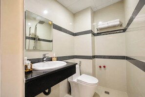 A bathroom with a sink, mirror, toilet, and shower. - Hotel Nhu Loan (Van Xuan)