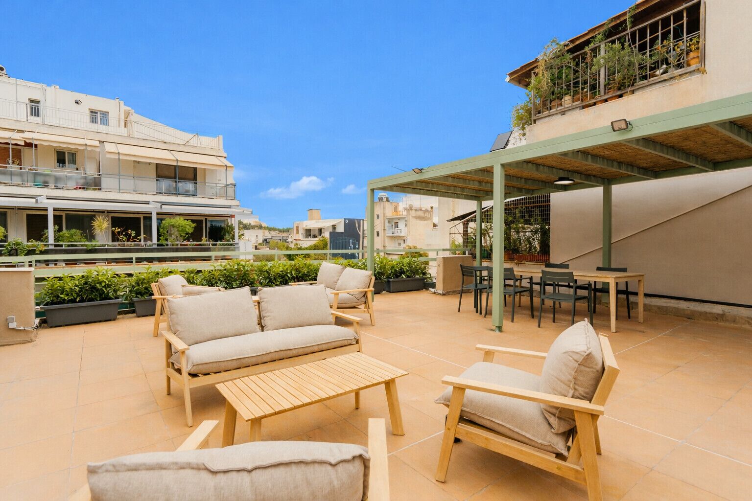 An outdoor patio with a sofa, chairs, and a table.