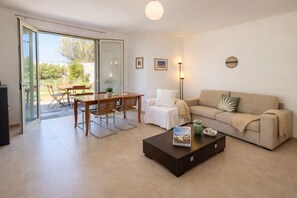 A modern living room with a sofa, coffee table, and dining area. - THE RED GELSO by Salento Sea Sky Travel Slow Live More (Nardo')