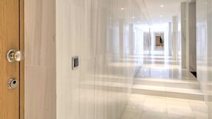 A hallway with marble flooring and walls, leading to a staircase. - 1-bedroom Lodge Stay in Antwerp (Antwerp)