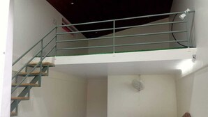 A room with a bunk bed, a staircase, and a ceiling fan. - Aarambh The Creek Breeze Resort (Palghar)