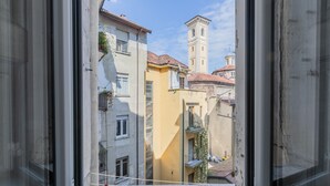 A narrow street with buildings, a window, and a tower. - Conte Verde - Bilo 7 Grey by Wonderful Italy (Turin)