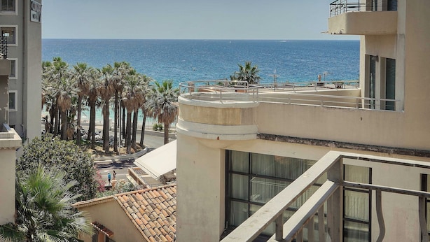 A coastal hotel with a view of the sea, palm trees, and a balcony with a railing. - Stunning Apartment a/c 6P With Sea View - Cannes (Cannes)