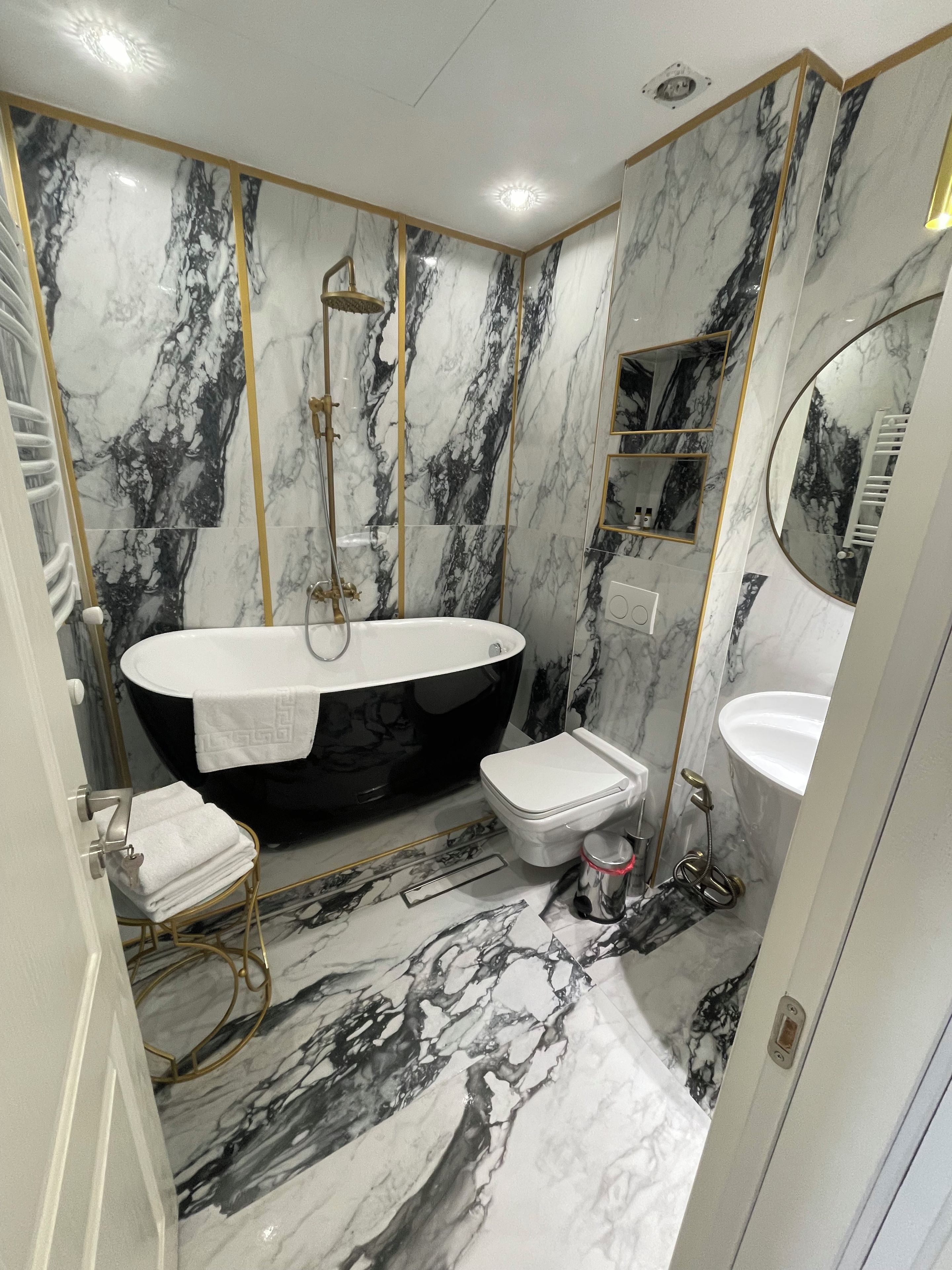A bathroom with a freestanding bathtub, a toilet, and a sink.