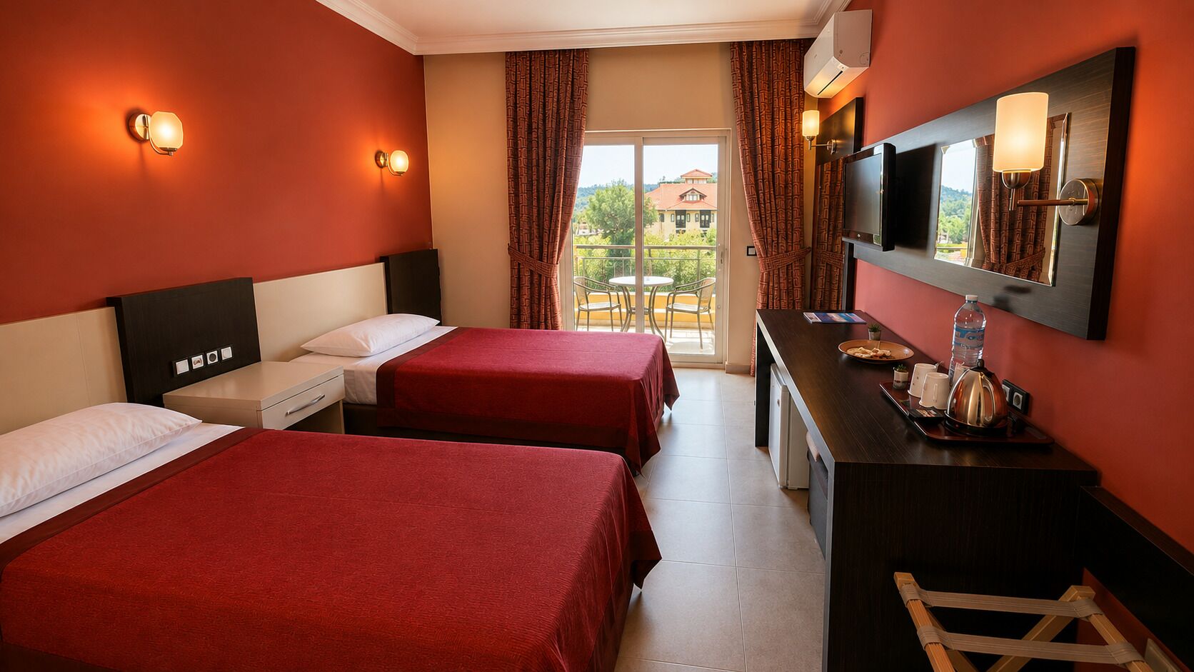 Habitación de hotel con dos camas, un escritorio con espejo y vistas al exterior.