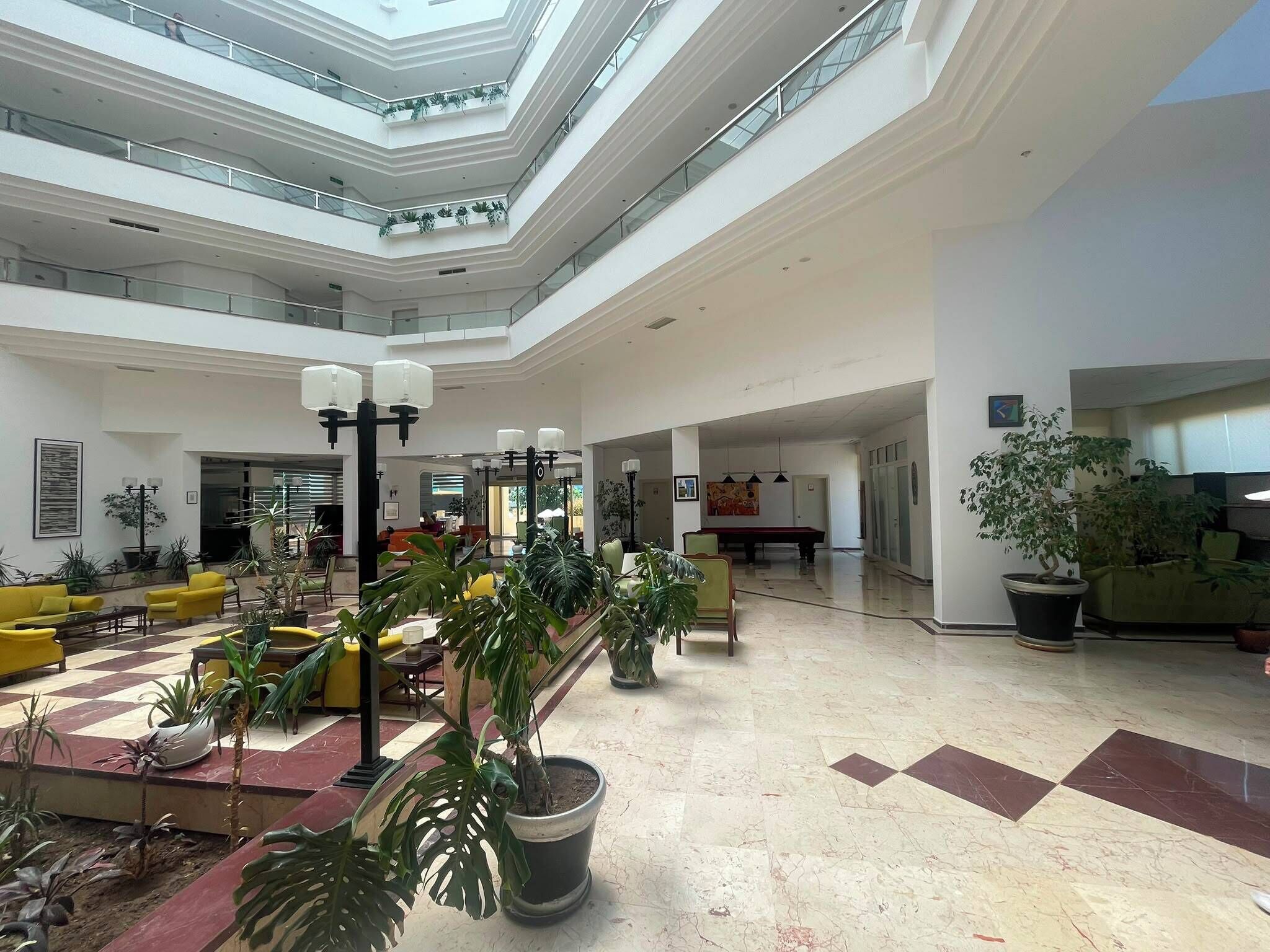 A spacious atrium with high ceilings, multiple levels, and a mix of seating areas.