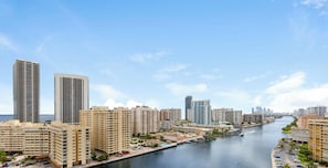 A waterfront cityscape with high-rise buildings, a marina, and a clear sky. - Stylish Studio w/ Intracoastal & Sunset Views (Hallandale Beach)