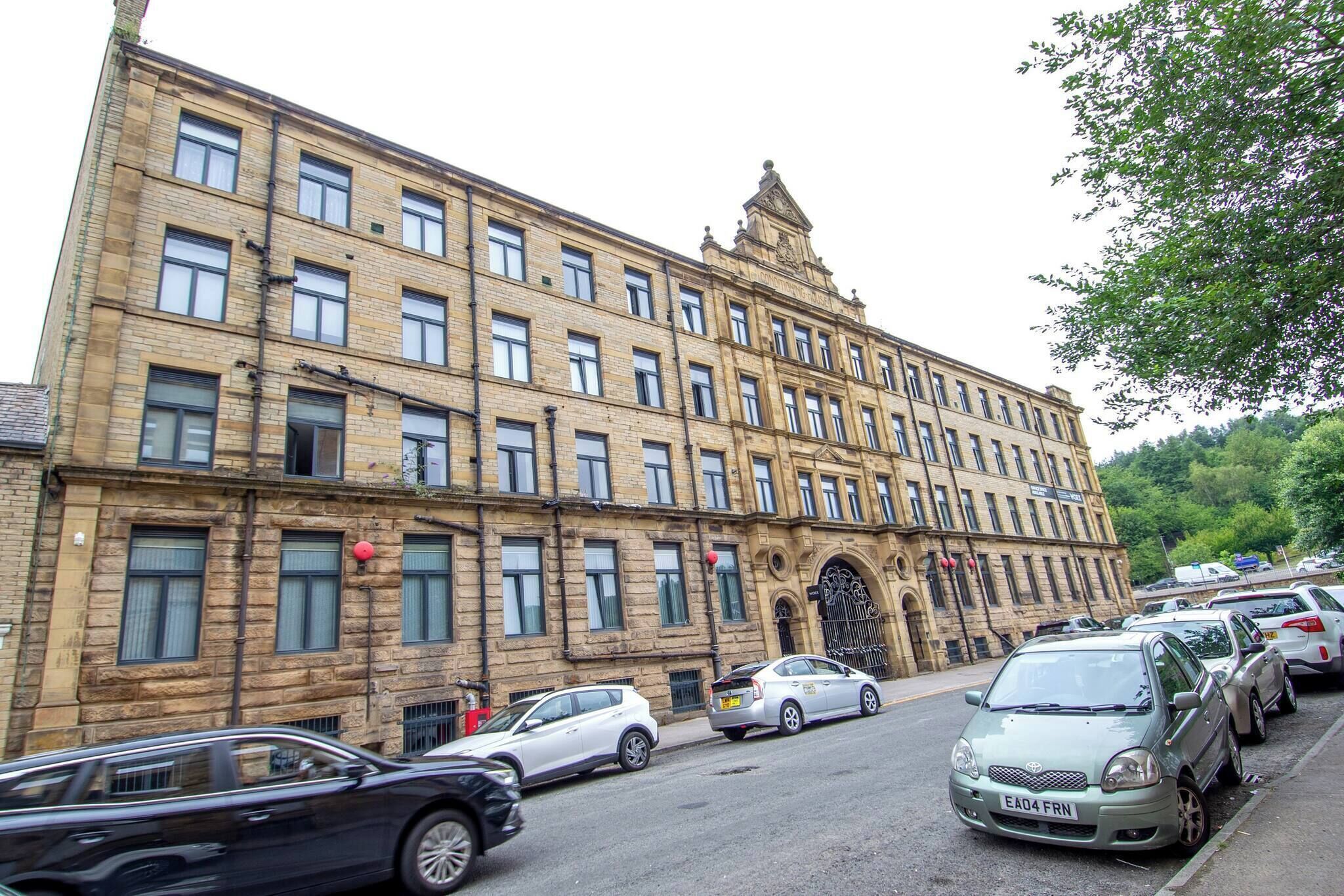 A multi-story building with a classic architectural style, featuring a prominent entrance with a decorative archway.