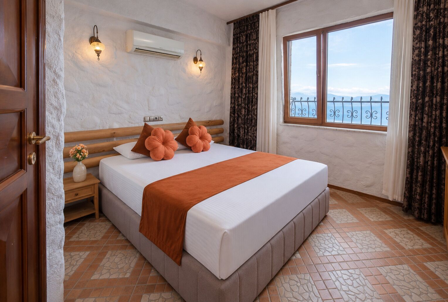 A bedroom with a bed, nightstand, lamp, air conditioning unit, window with curtains, and a view of the outside.
