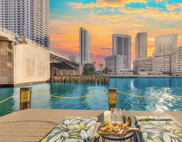 A waterfront hotel with high-rise buildings in the background, a swimming pool, and caution signs along the poolside. - Top-Floor Intracoastal · 2BR Beachwalk Resort (Hallandale Beach)