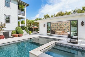 A residential property with a swimming pool, a patio with outdoor furniture, and a covered area with a table and chairs. - Maison Barnard | Starland's Most Stunning Home + Private Pool, Event Space (Savannah)