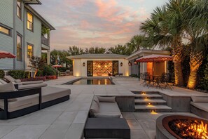 A residential outdoor area with a swimming pool, seating, and a fire pit. - Maison Barnard | Starland's Most Stunning Home + Private Pool, Event Space (Savannah)