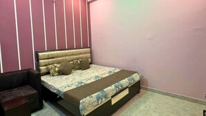 Ein Schlafzimmer mit einem Bett, einem Deckenventilator und einem Nachttisch.