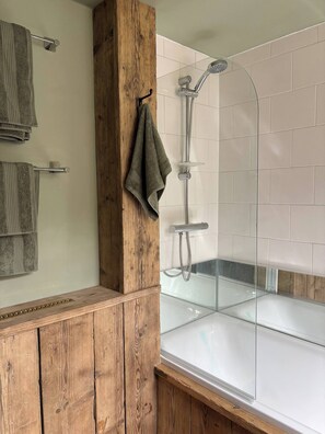 A bathroom with a wooden vanity, a glass shower enclosure, and a bathtub. - Quaint Townhouse in the Centre of Chipping Norton (Chipping Norton)